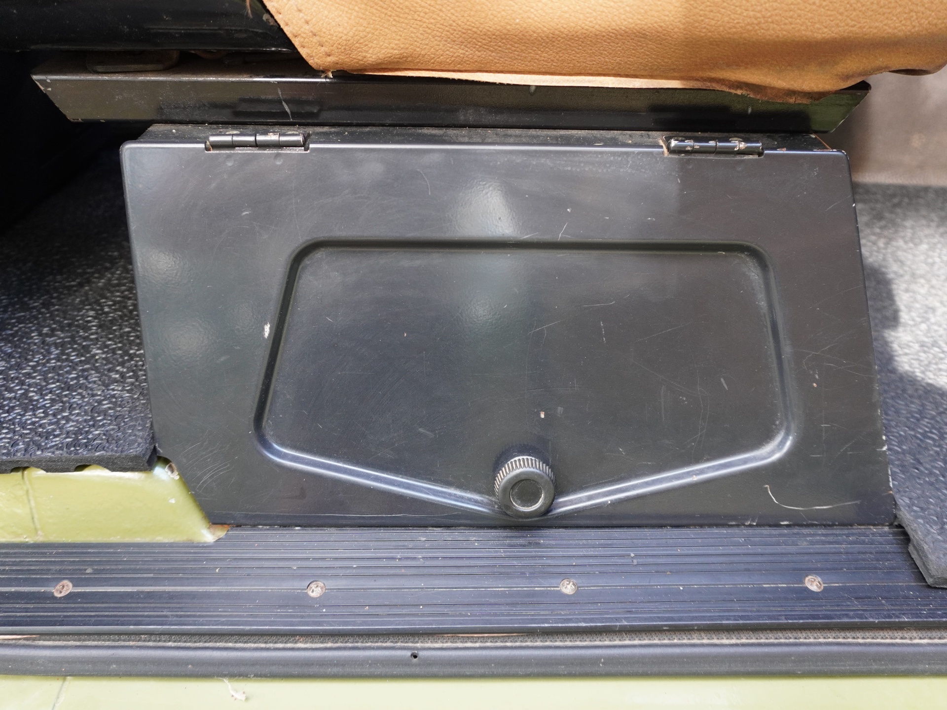 Under-seat storage compartment with lift-up lid