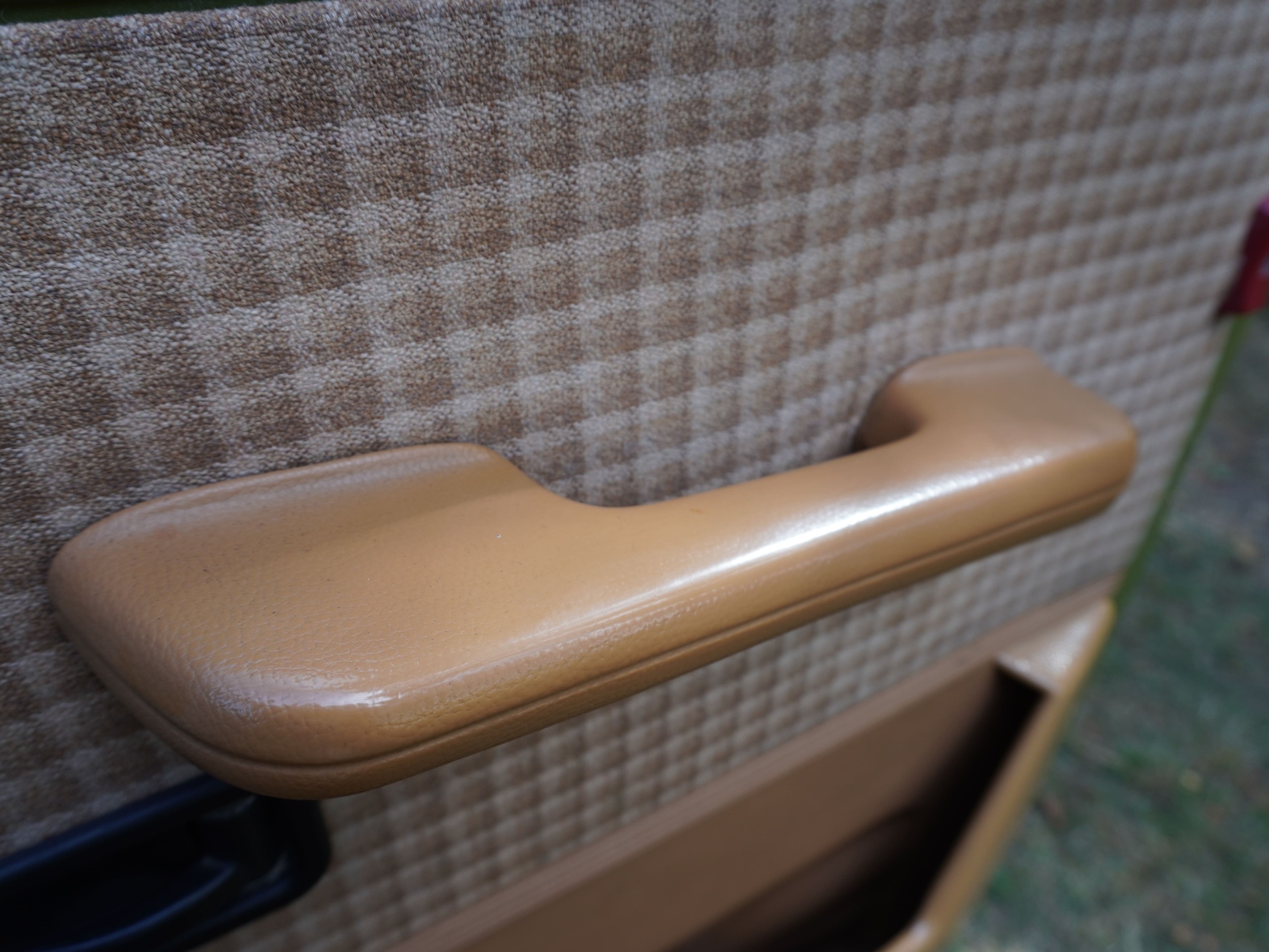 Tan grab handle on houndstooth door card